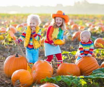 Laughing kids in a pumpkin patch